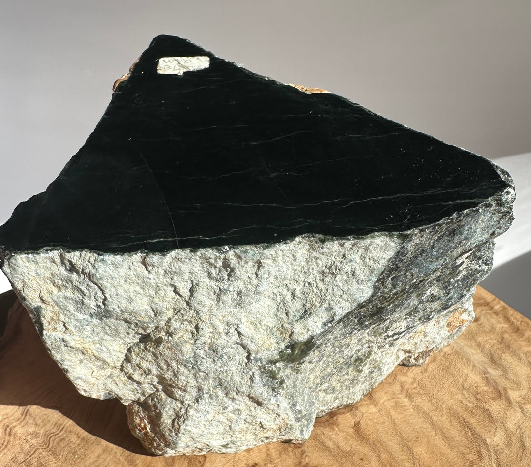 Side view of Wyoming Black Jade 3lb 10oz slab with a jagged peak and dark surface against a neutral background.