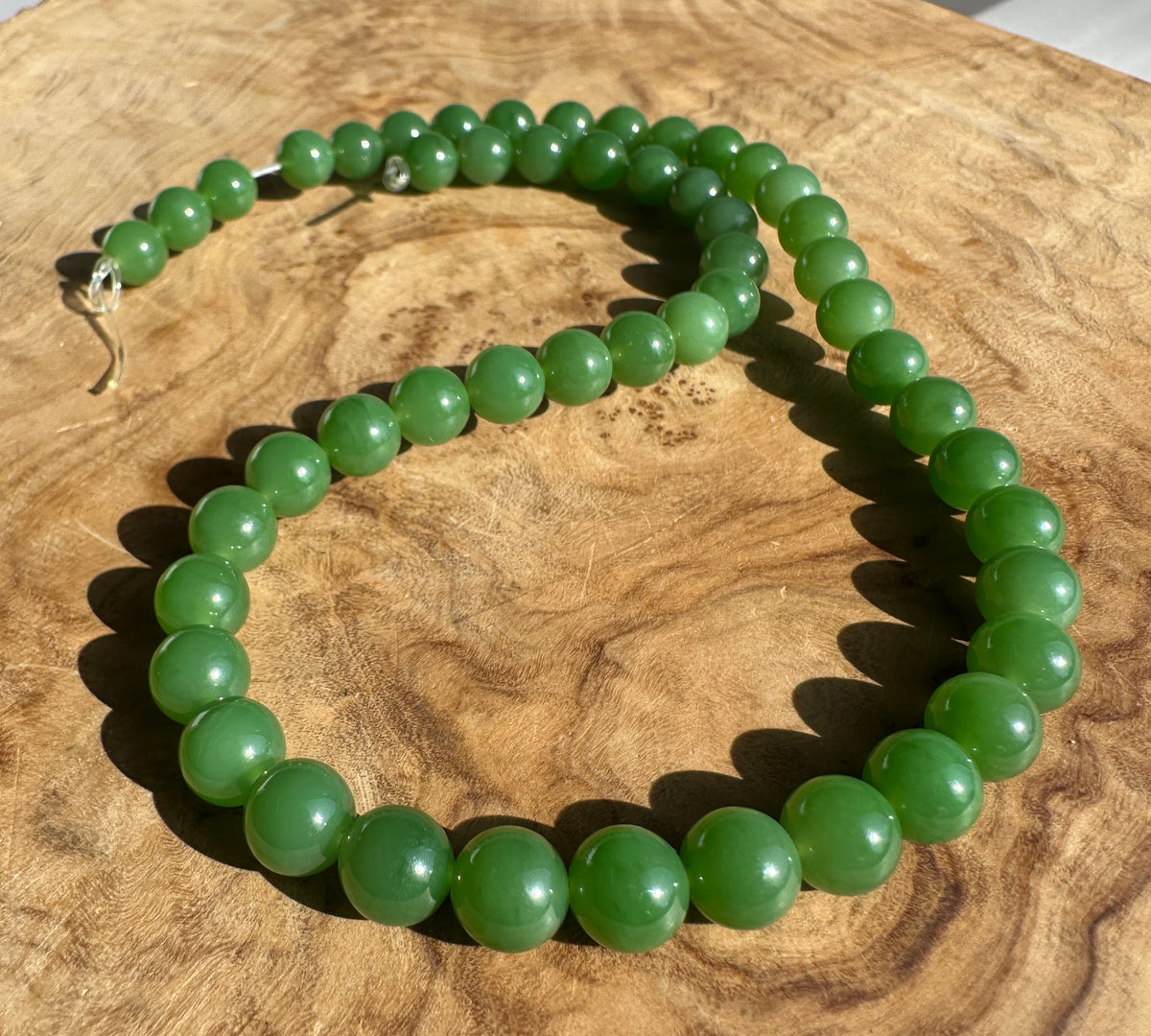 Unstrung 16 inch strand of 8mm AA grade Siberian jade beads in green