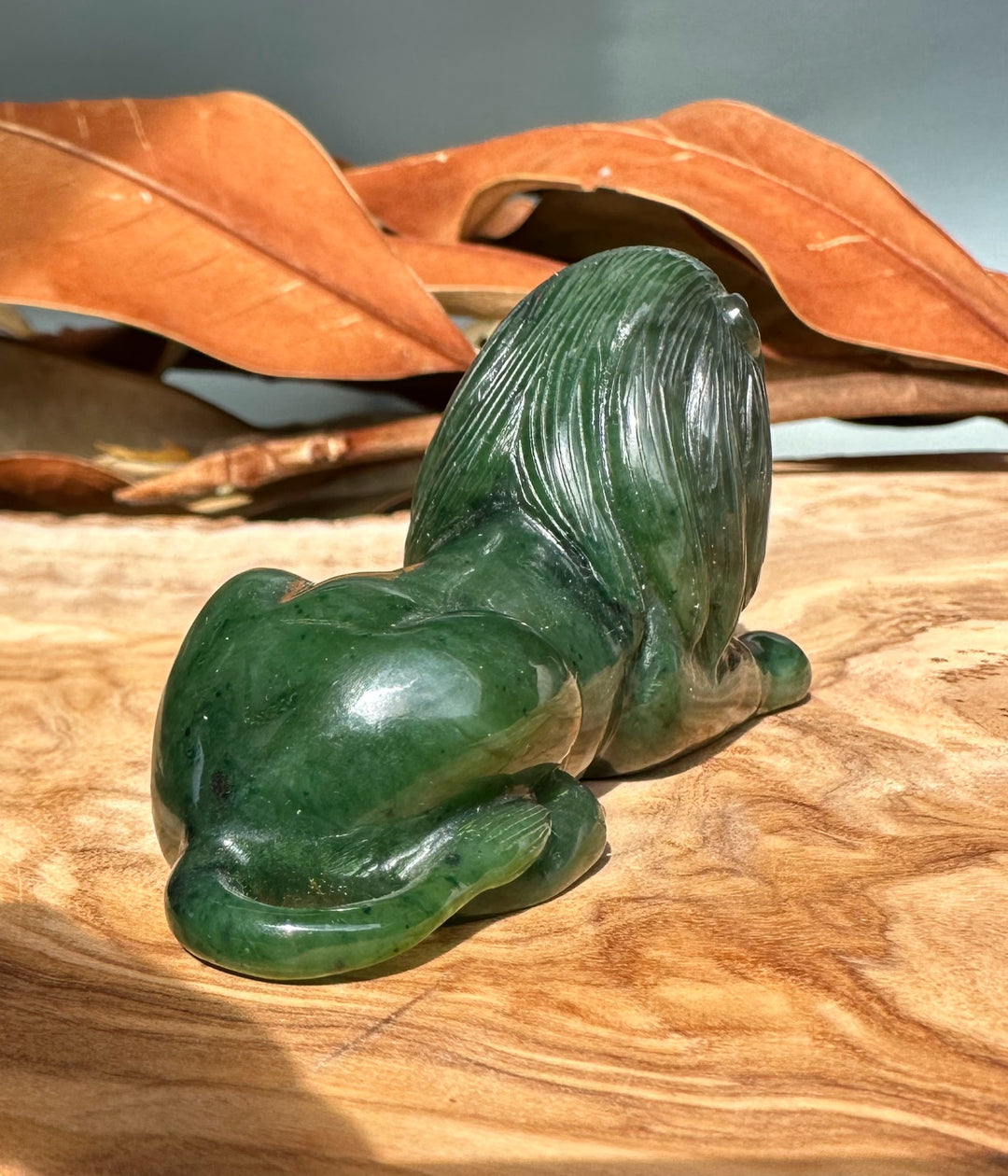 Rear view of the 3 inch Canadian jade lion figurine highlighting its flowing mane.