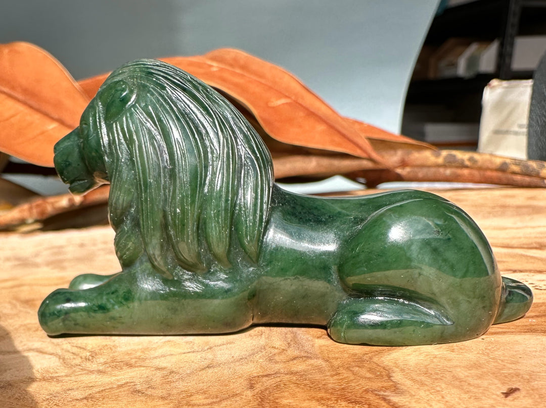 Canadian jade lion statue lying down with a detailed flowing mane
