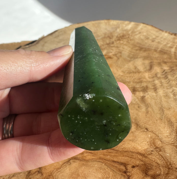Detail shot of the Jade tower held in hand showing the pointed top and marbled green color.