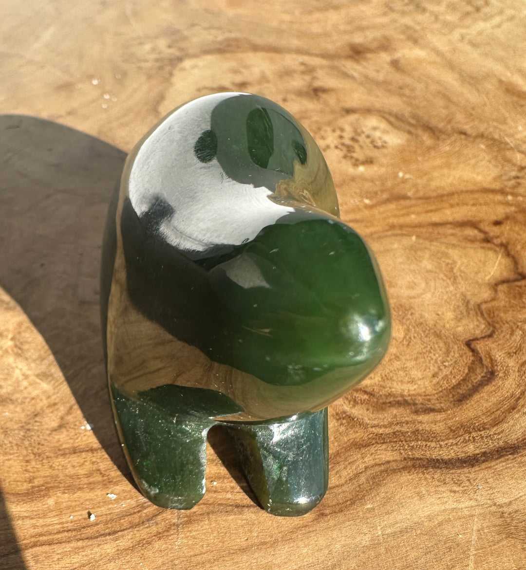 Close up of green nephrite jade pendant with silver chain