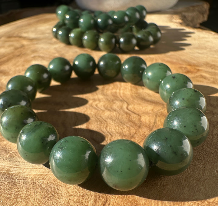 12mm River Canadian nephrite jade bead bracelet on wood surface