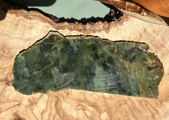 Wyoming Jade Slab green with turtleback pattern on a natural wood background