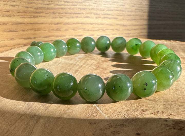 Medium Green bead bracelet on a wood base