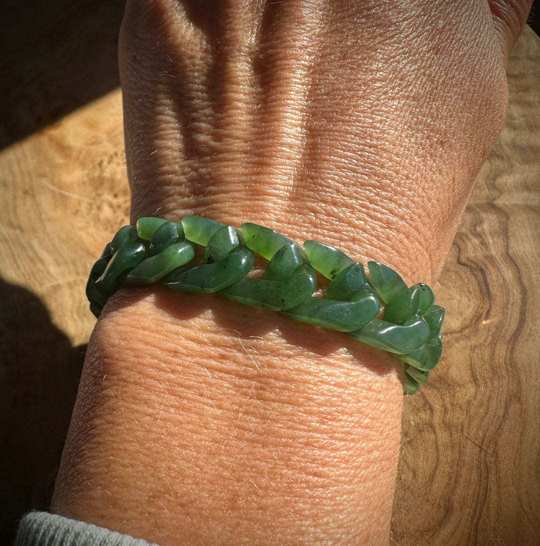 Chunky green nephrite bead bracelet wrapped around the wrist