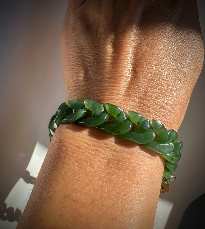 Wrist worn emerald green nephrite Cuban link bracelet with glossy curved links