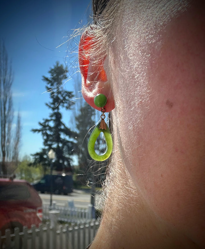 Vintage jade drop earring on ear with lime green teardrop pendant and copper cap