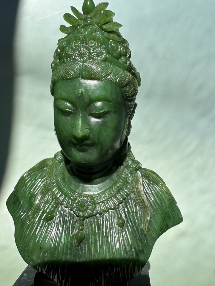 Green Guanyin statue 5 inches with ornate crown and beaded necklace on a dark pedestal.