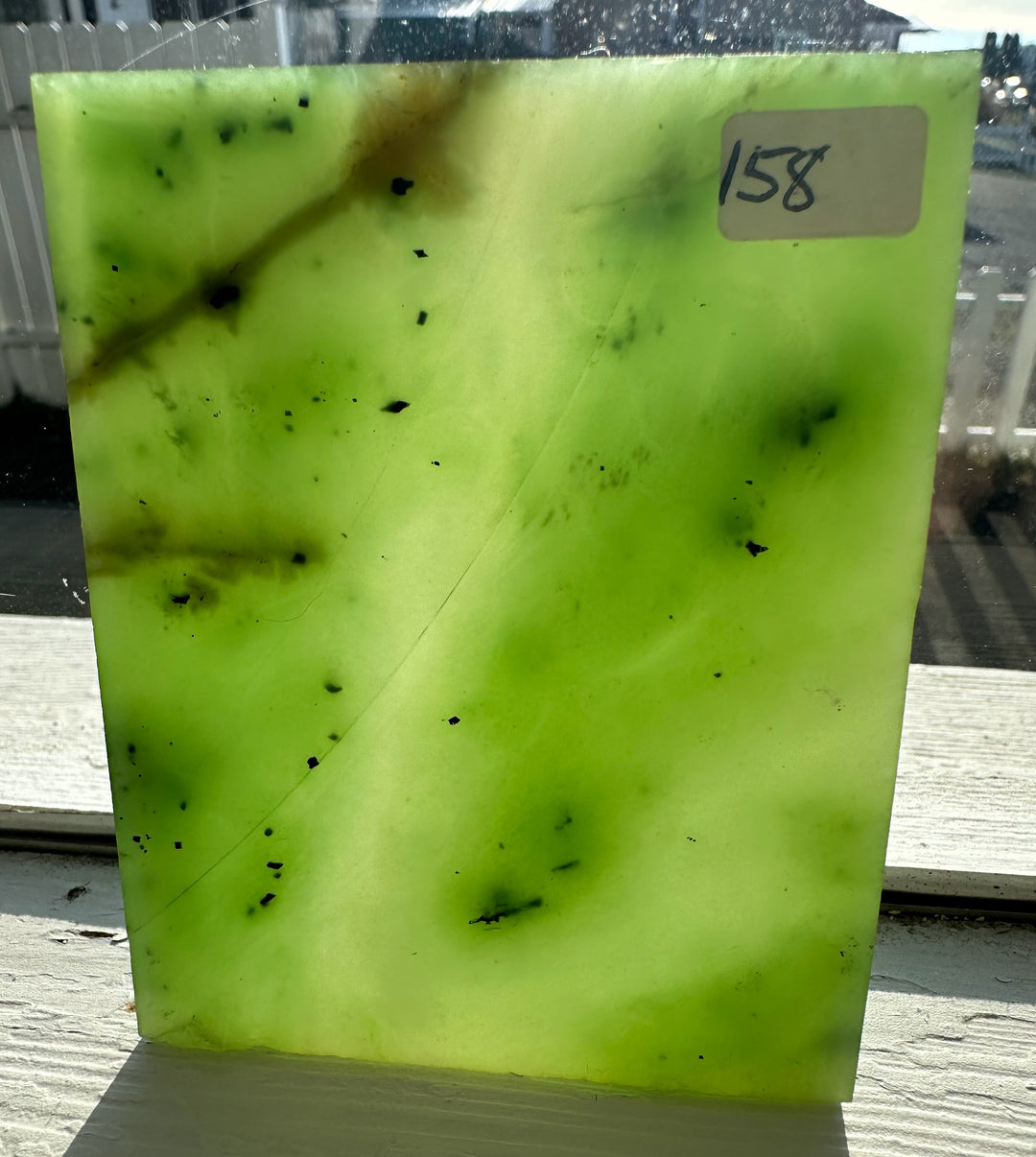 155-gram Siberian nephrite jade slab in neon lime green with dark specks