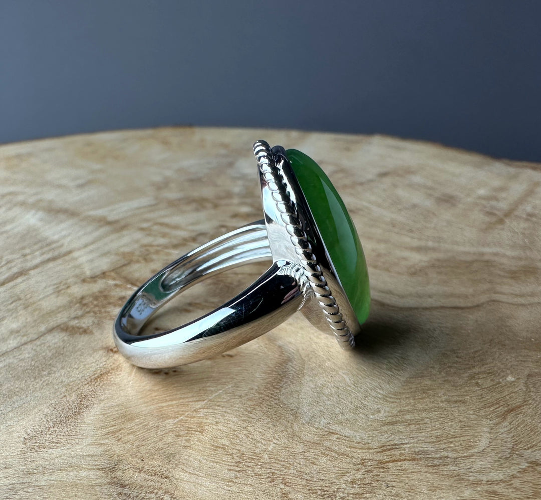 Canadian Jade Silver Ring with a green oval jade set in a twisted rope bezel on a polished silver band