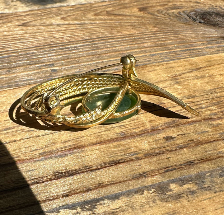 Gold tone Vintage Canadian Jade Brooch showing the green jade center with layered curling textured arcs