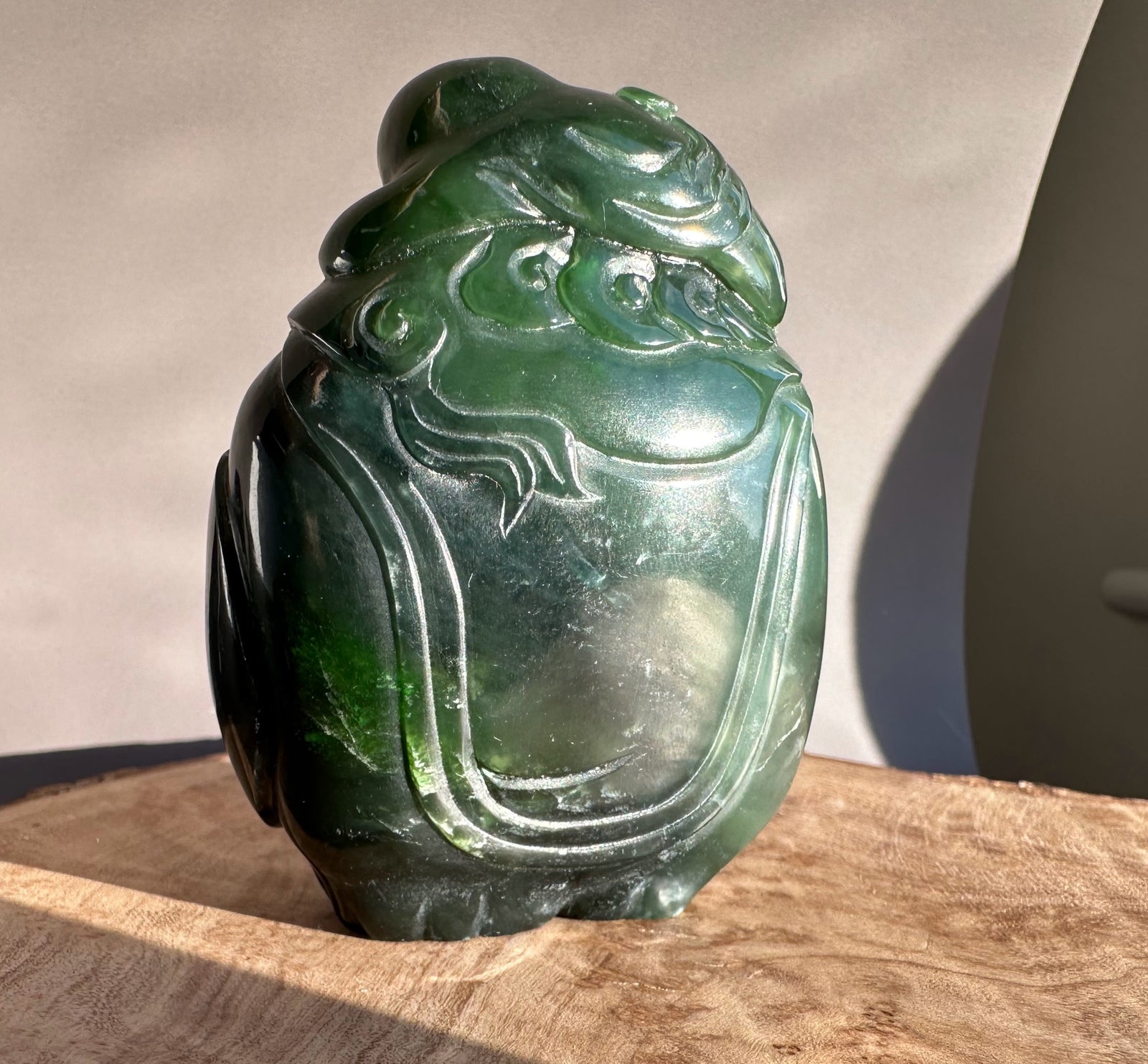 Side view of the jade sculpture showing the rider atop the elephant and carved robe details.