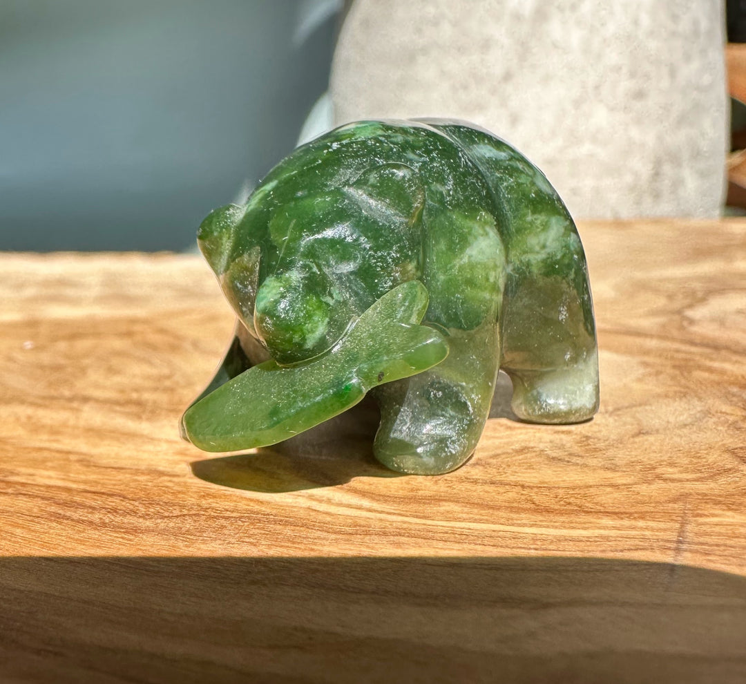 Bear Special green jade bear sculpted with a jade fish in its mouth.