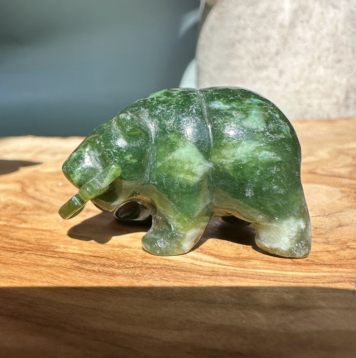 Single jade bear sculpture with a jade fish in its mouth.
