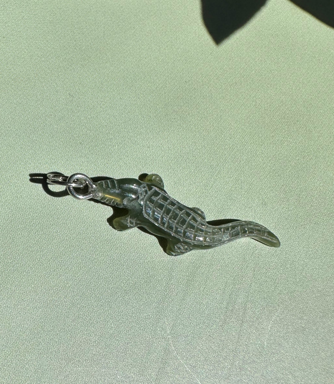 Dark green jade alligator charm with a metal loop for pendant
