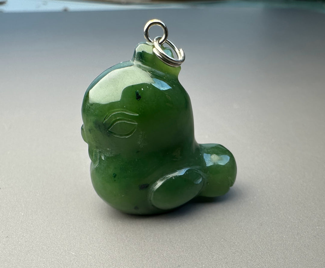 Green cartoon rooster charm with a metal loop for attaching to a bracelet or necklace