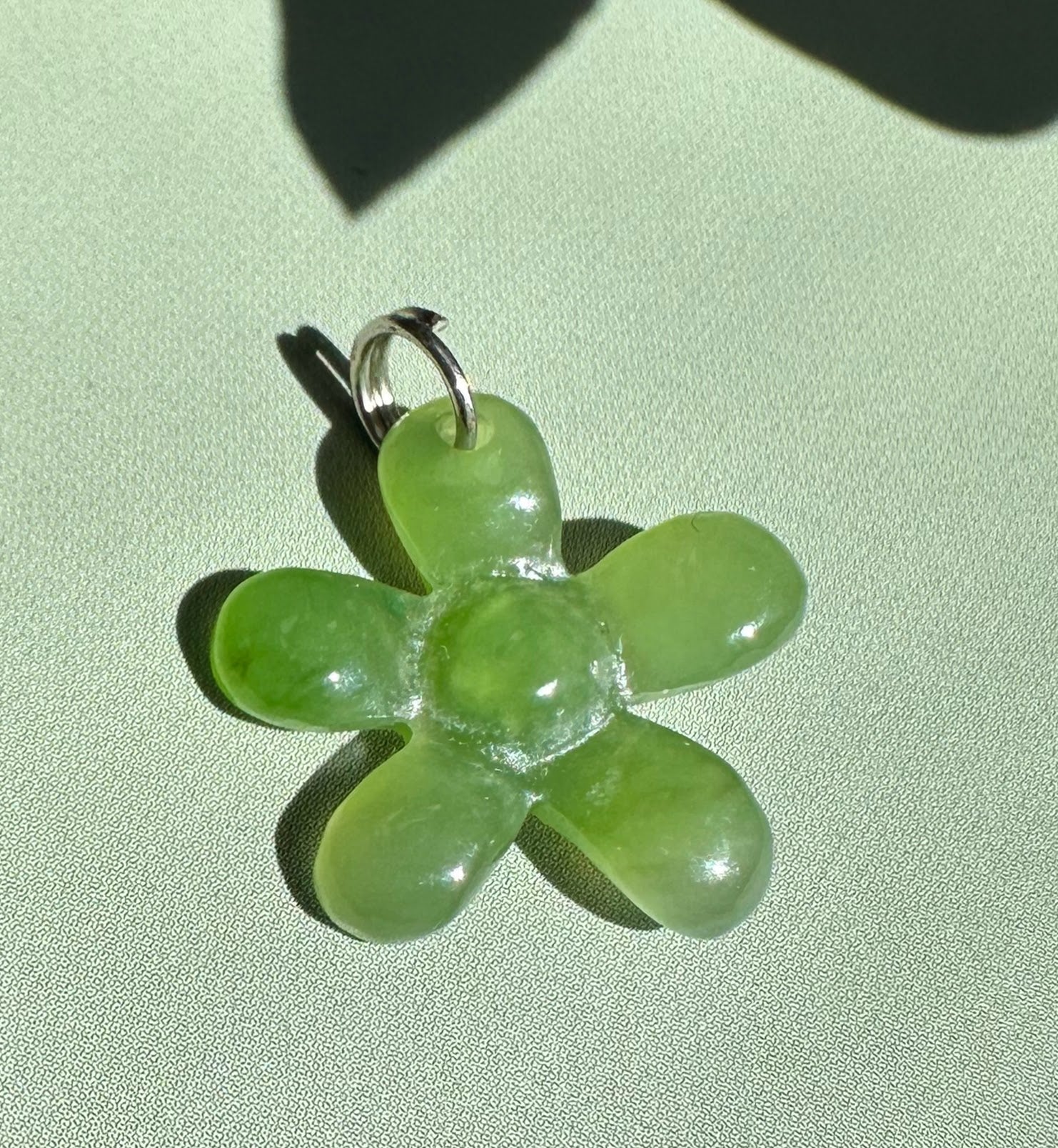 Green jade flower charm 16mm with a metal loop for necklace