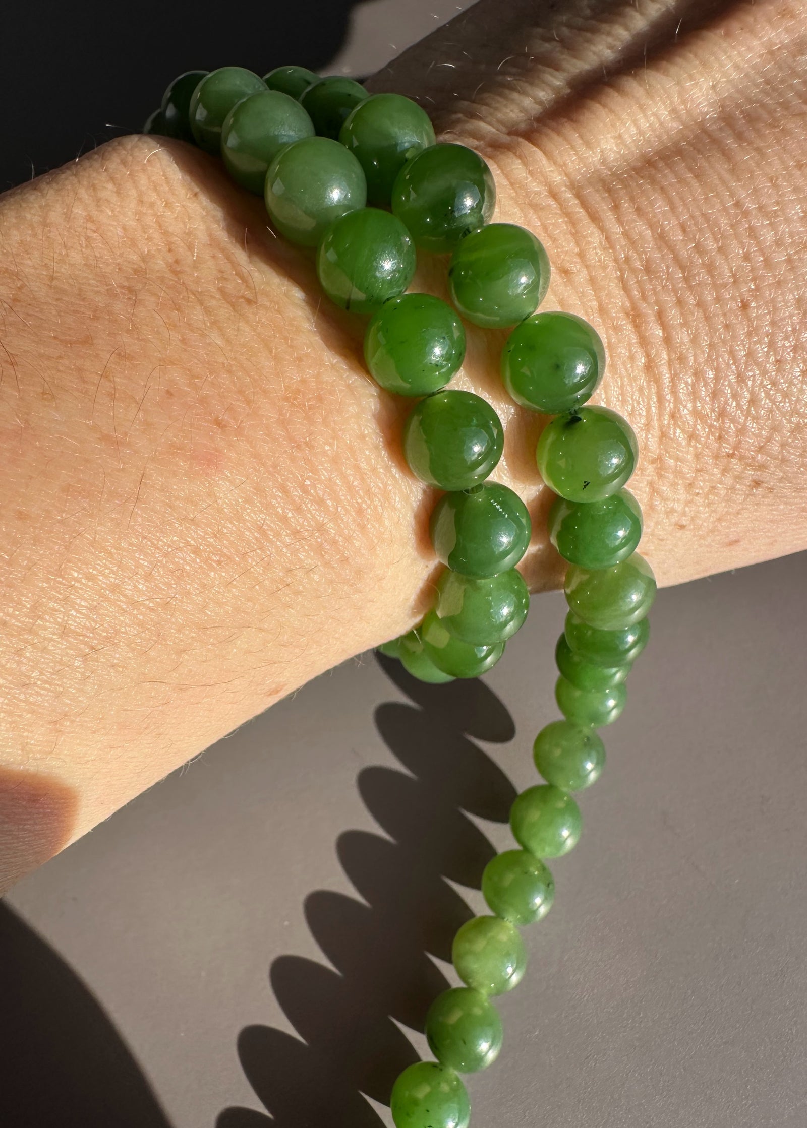 8mm green Canadian beads bracelet worn on the wrist