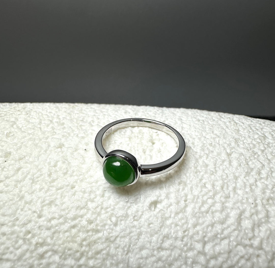 Silver ring with a round green jade cabochon.