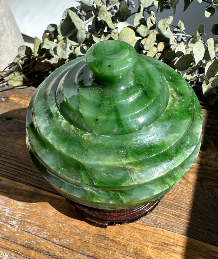 Top view of Polar Jade Pot lid with a rounded knob, showing layered green jade.