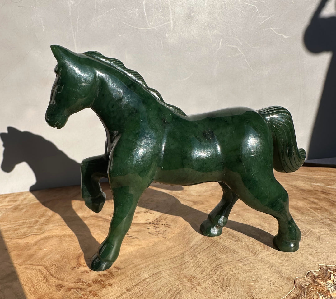 Canadian nephrite jade horse figurine five inches, glossy dark green with a raised foreleg.