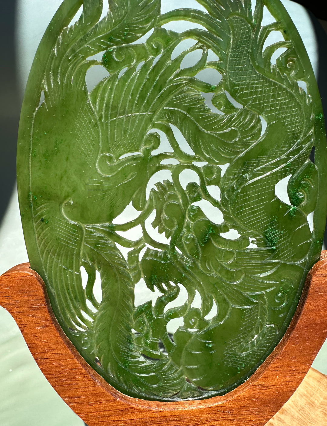 Close-up of the oval green jade screen showing detailed dragon and phoenix carving