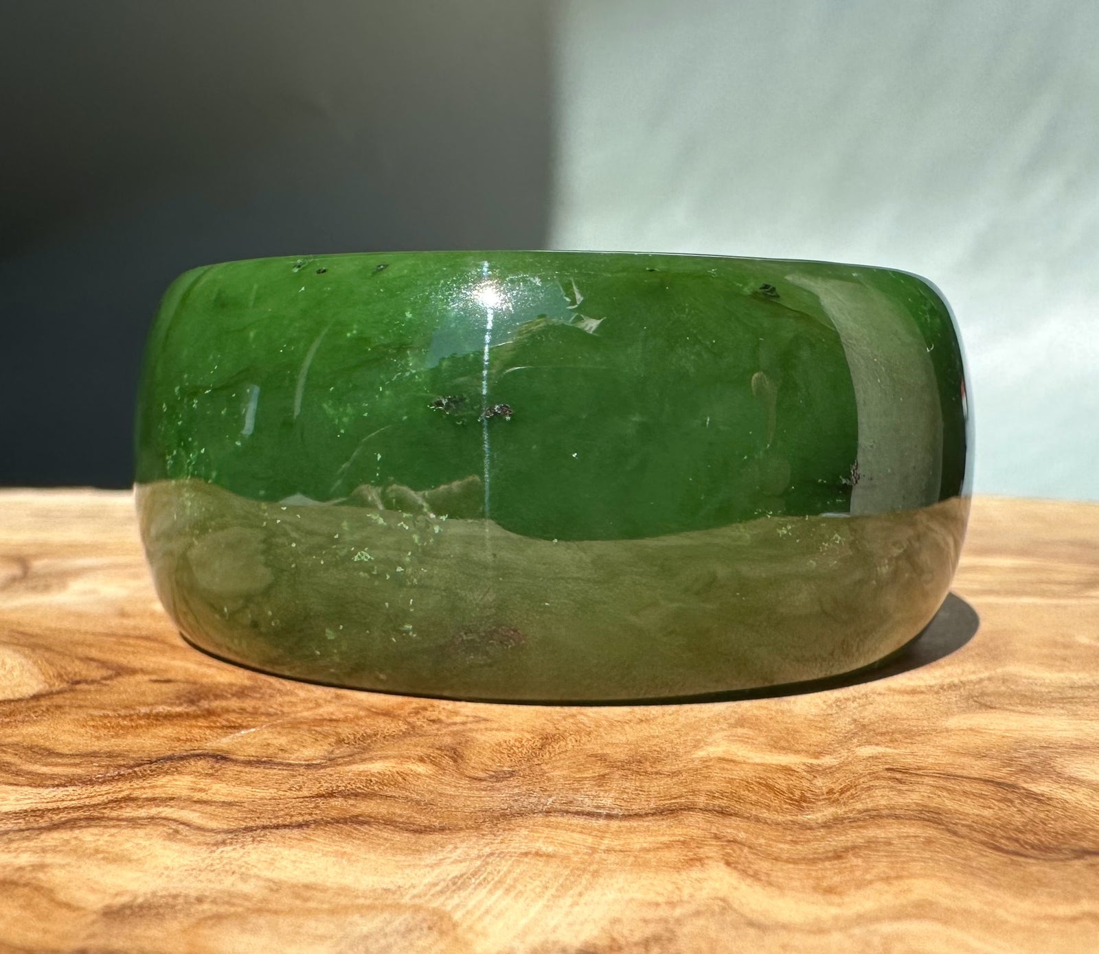 Wide Cassiar jade bangle in two tone green with a lighter lower band 56x29.5mm