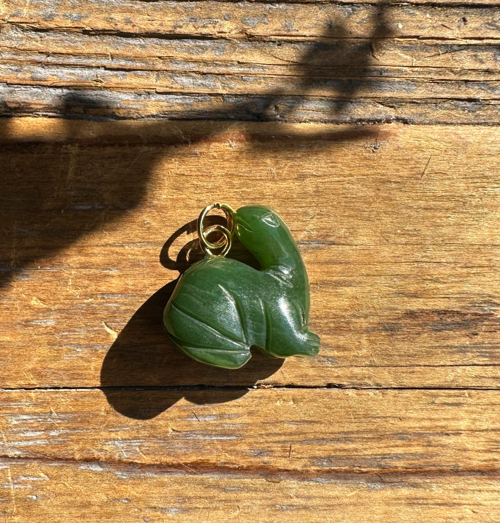 18mm green jade dinosaur charm with a gold bail.