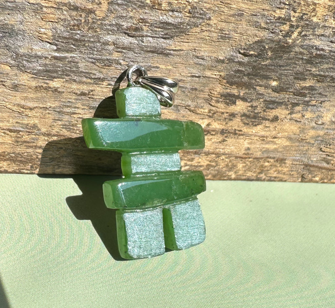 Inukshuk pendant crafted from stacked green jade pieces with a silver bail.