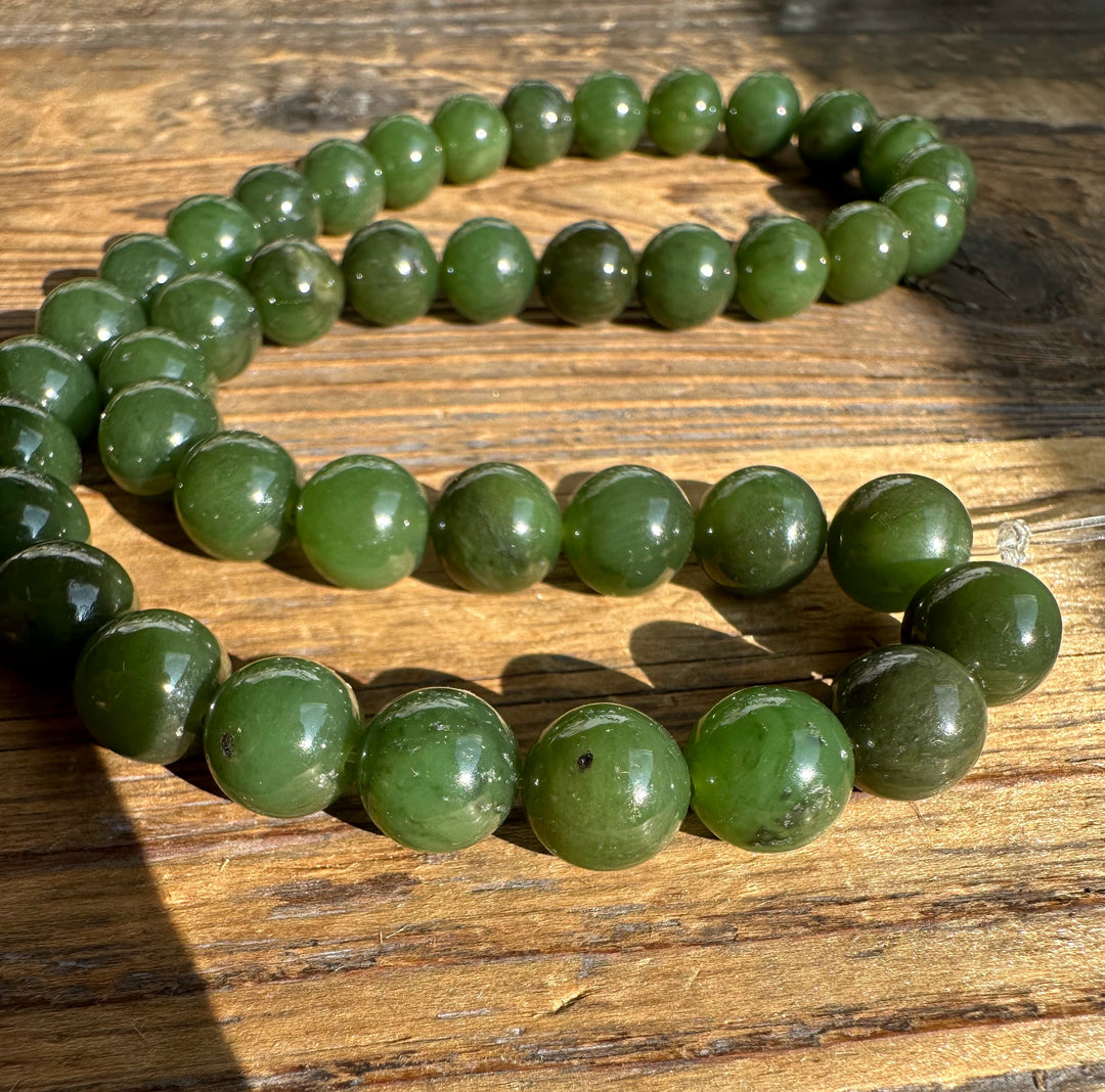 Unstrung Canadian 10mm carving grade beads arranged in a circle on a wooden surface