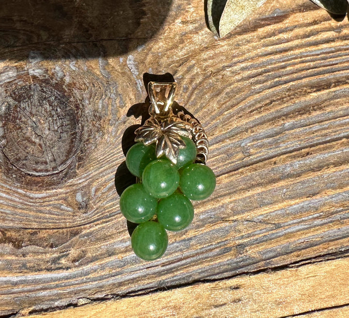 Vintage jade grape pendant with a cluster of green jade beads beneath a leaf cap.