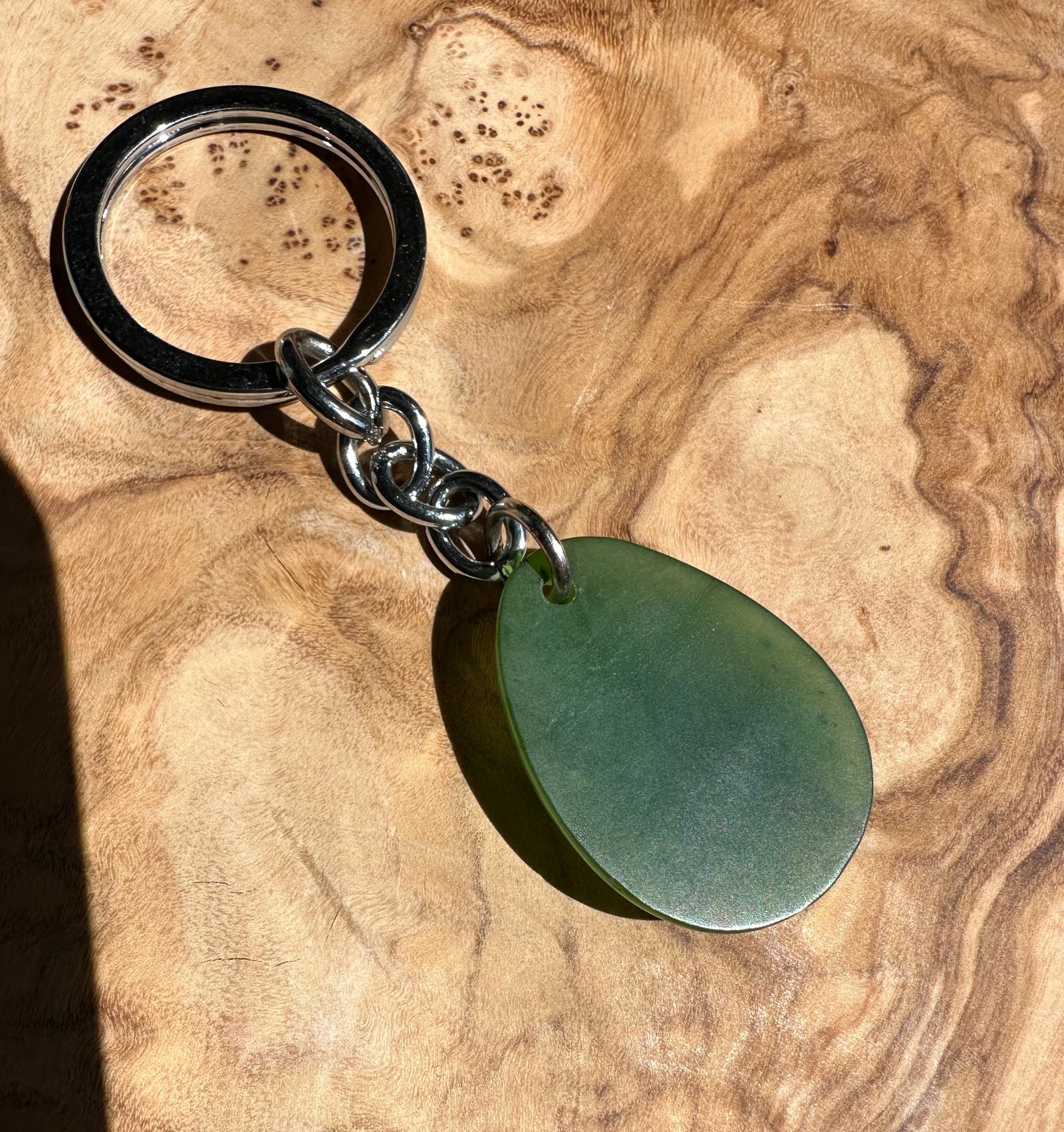 Green teardrop keychain pendant attached to a chunky circular metal key ring via a silver chain