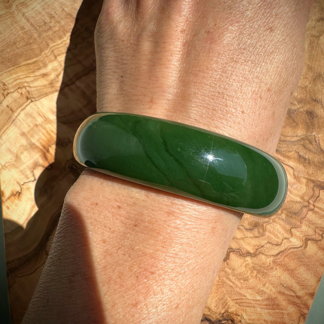 AA Canadian Jade Bangle on wrist, smooth deep green 60 by 19 mm.