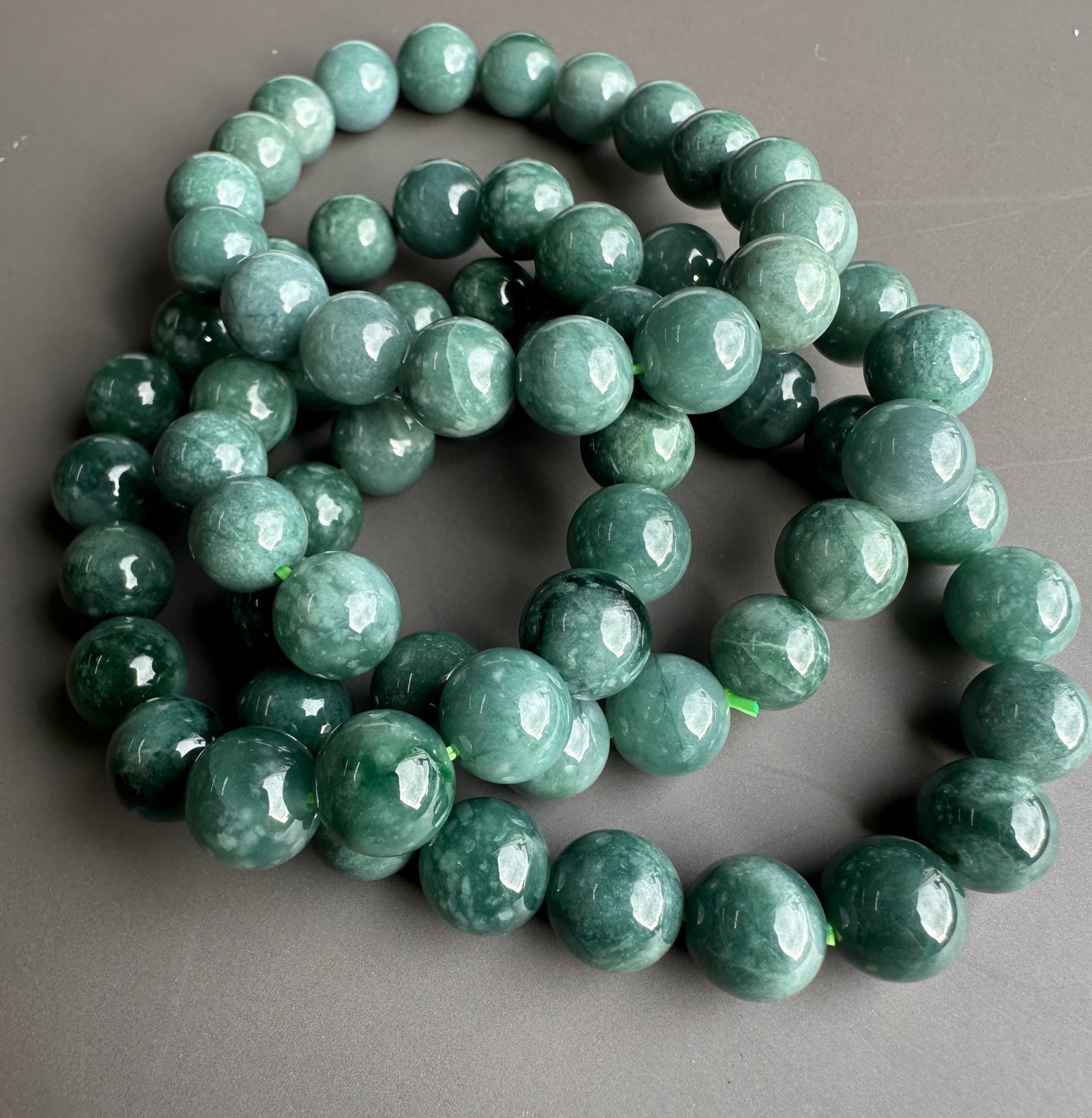 Guatemalan jadeite beads 10mm, glossy green spheres forming a bracelet