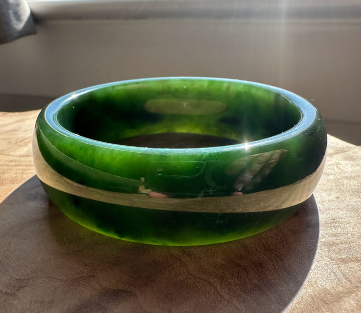Canadian Jade Bangle with a central light beige band across the dark green jade