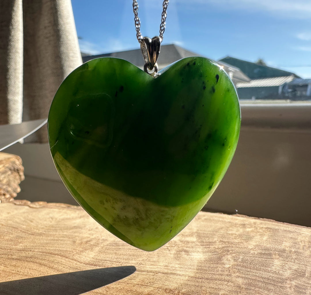 A+ Polar Jade large green heart pendant on a silver chain.