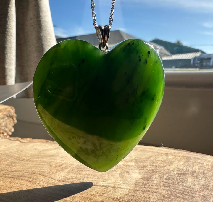 A+ Polar Jade large green heart pendant on a silver chain.