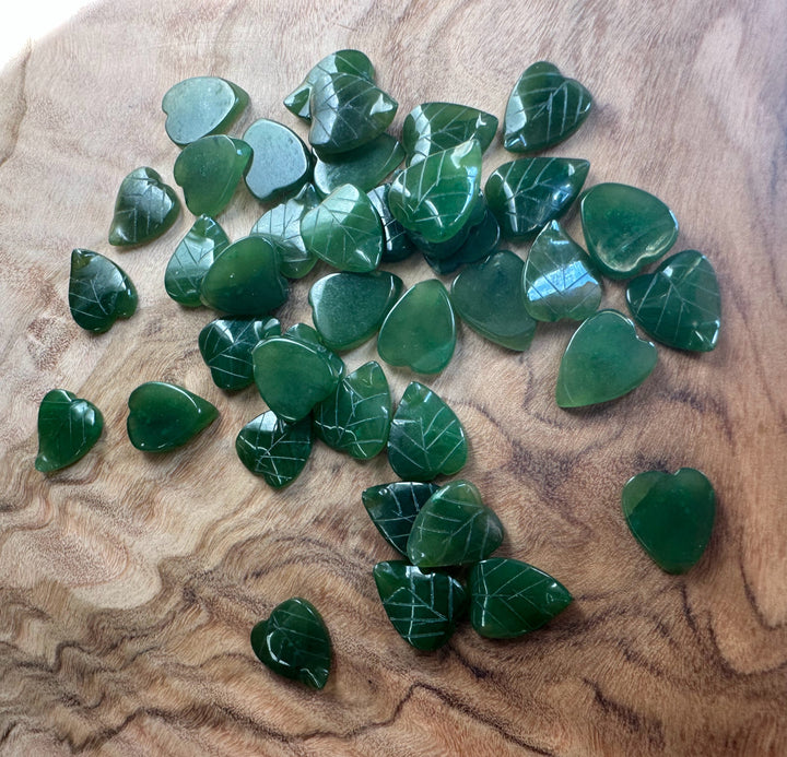 Canadian Jade Leaf beads 9x8mm close up with white vein lines on a wooden background