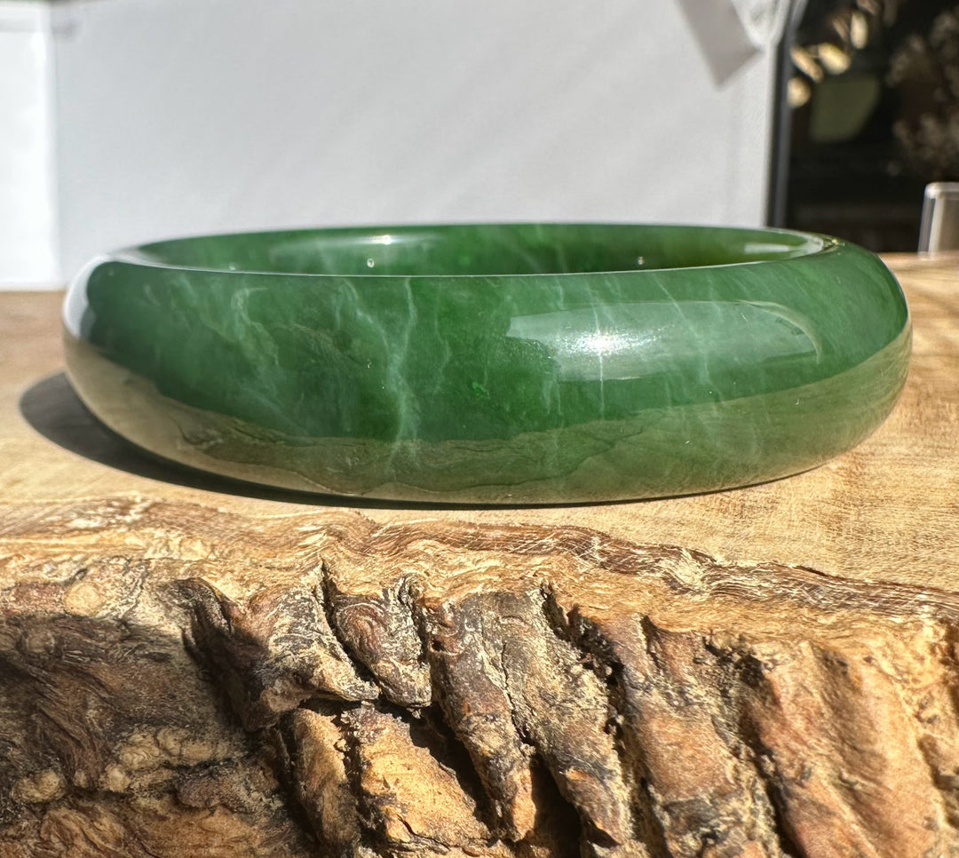 Canadian Jade Bangle 54.5 x 15mm in smooth green jade shown from the side to highlight the rounded edge
