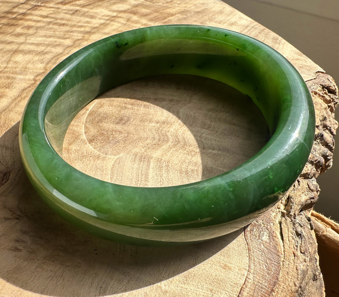 Canadian Jade Bangle 54.5 x 15mm in vivid green jade viewed from above to show its thick rounded form