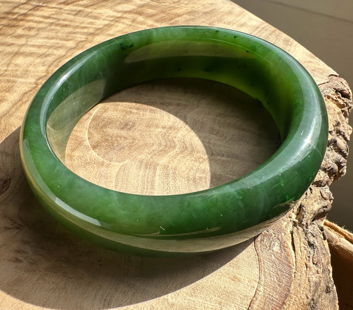 Canadian Jade Bangle 54.5 x 15mm in vivid green jade viewed from above to show its thick rounded form