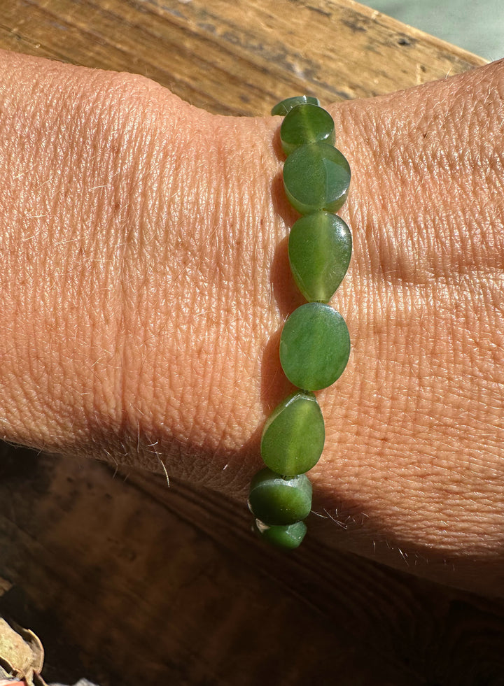Green Canadian jade bead bracelet worn on the wrist, 7.75 inches long