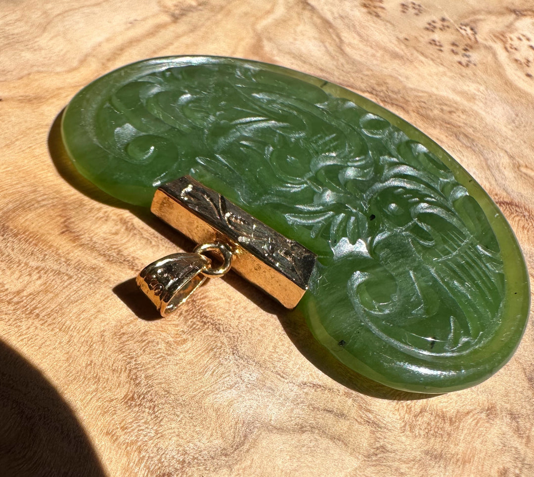 Vintage Jade Birds Pendant in green jade with carved scroll pattern and a gold bail.