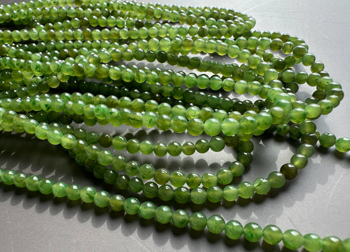 Close up of unstrung 3.5mm green nephrite jade beads