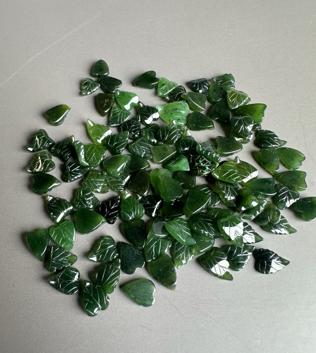 Pile of glossy Canadian jade leaf chips in deep green
