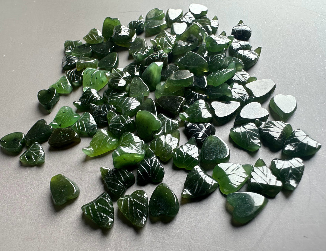 Dark green glossy jade leaf chips with white vein markings and heart shapes