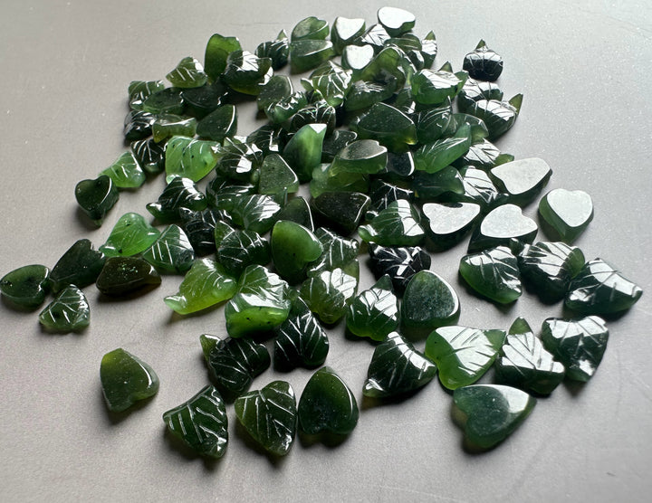 Dark green glossy jade leaf chips with white vein markings and heart shapes