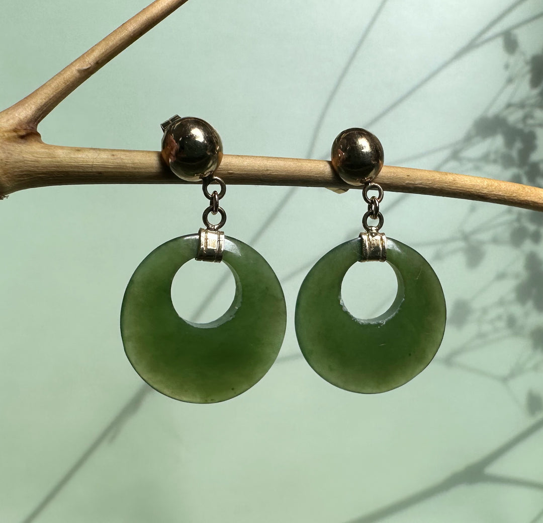 Green jade round drop earrings with hollow center and silver-toned caps