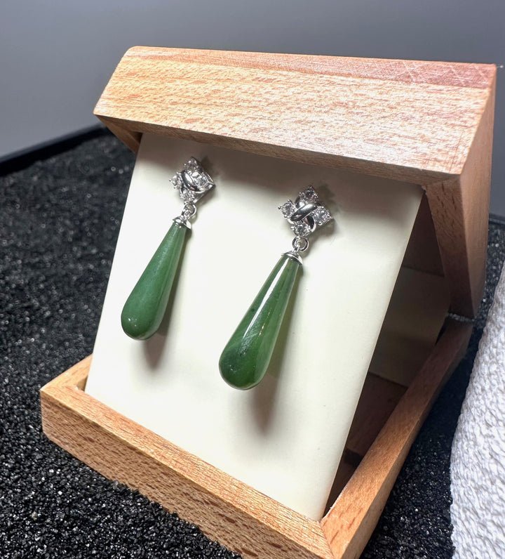 Pair of silver drop earrings featuring green jade teardrops and clear crystal tops